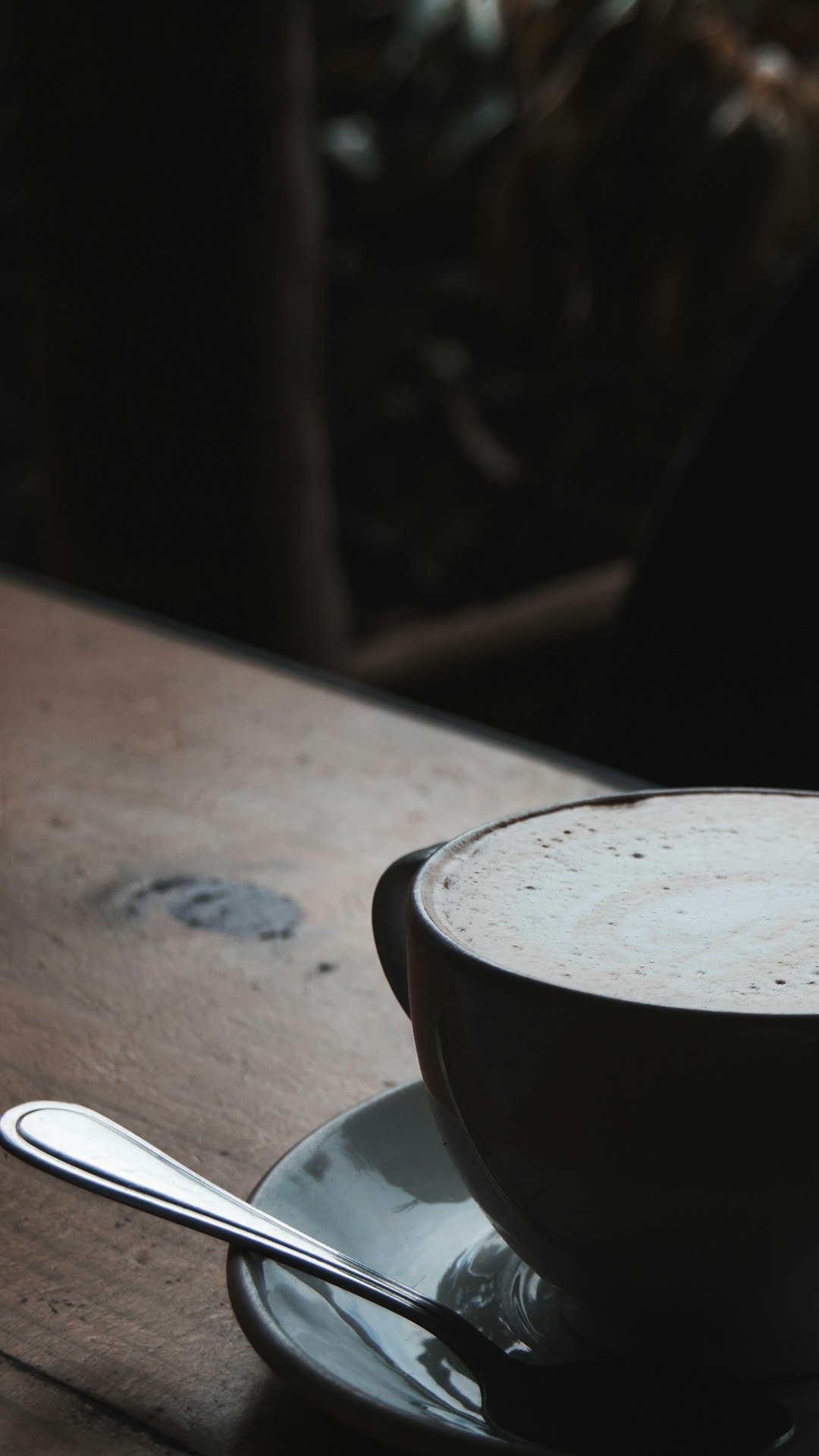 black ceramic mug on brown wooden table