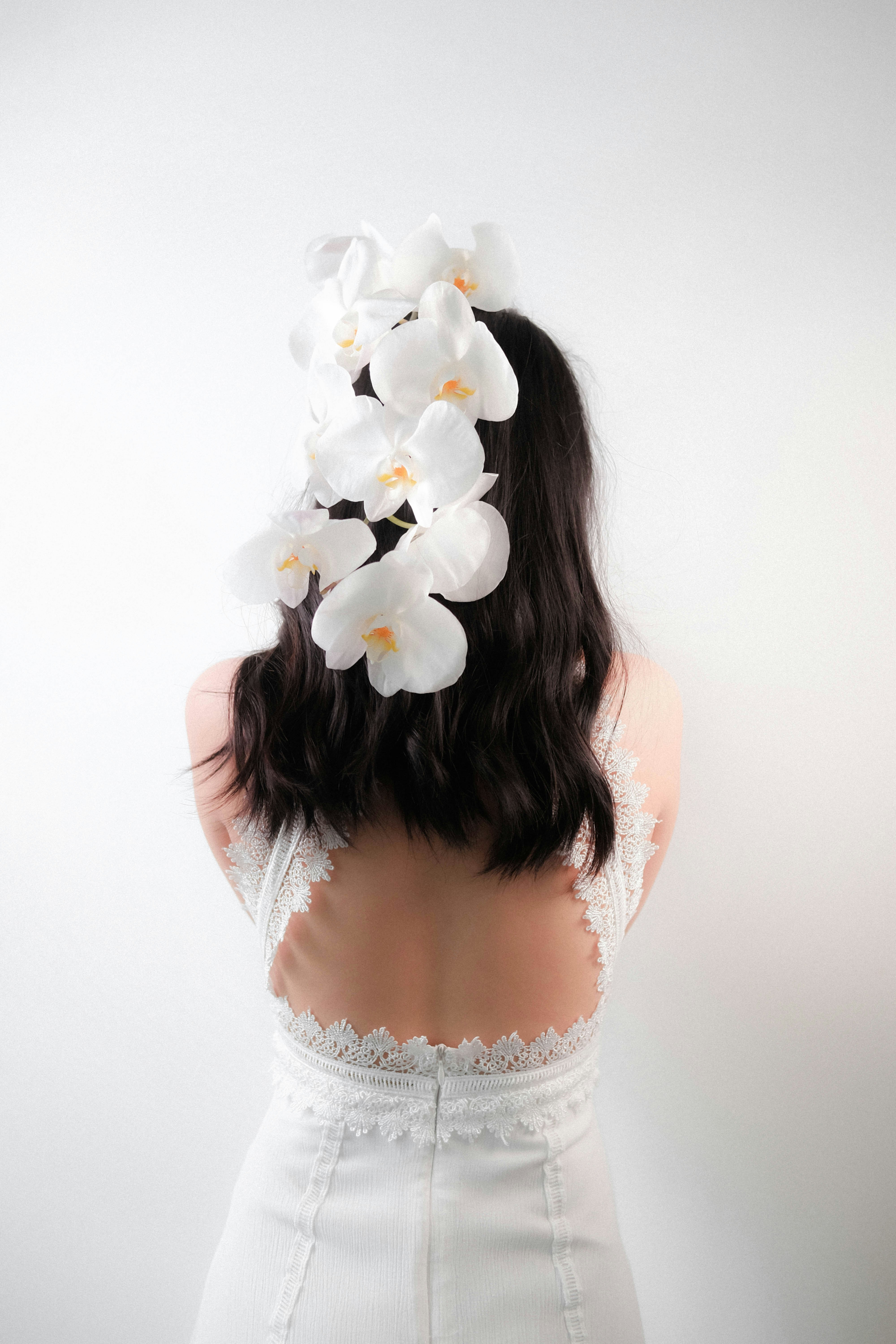 woman-in-white-lace-top-with-white-flower-on-her-head