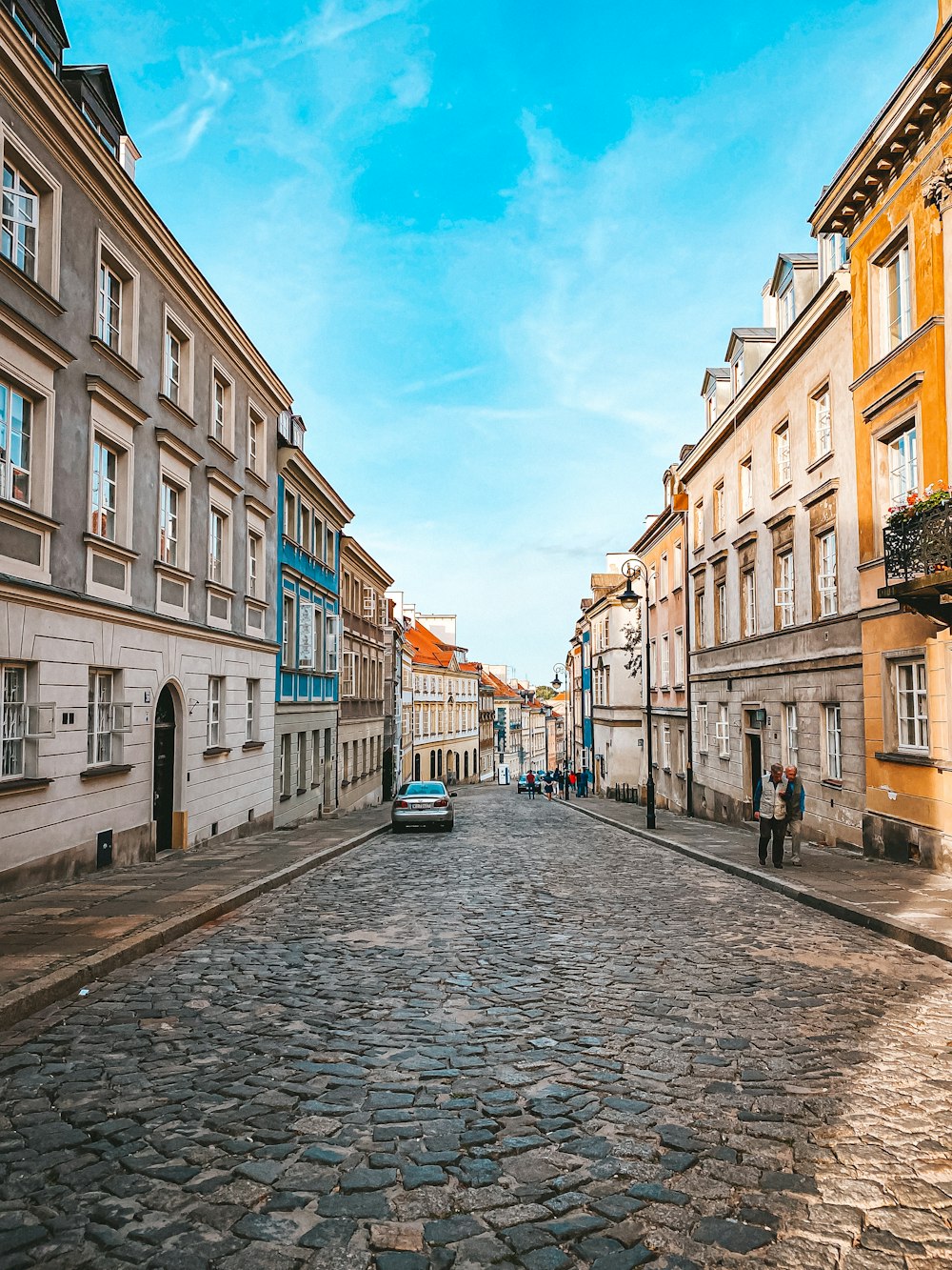 people walking on street between buildings during daytime