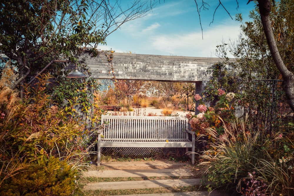 white wooden bench near brown wall