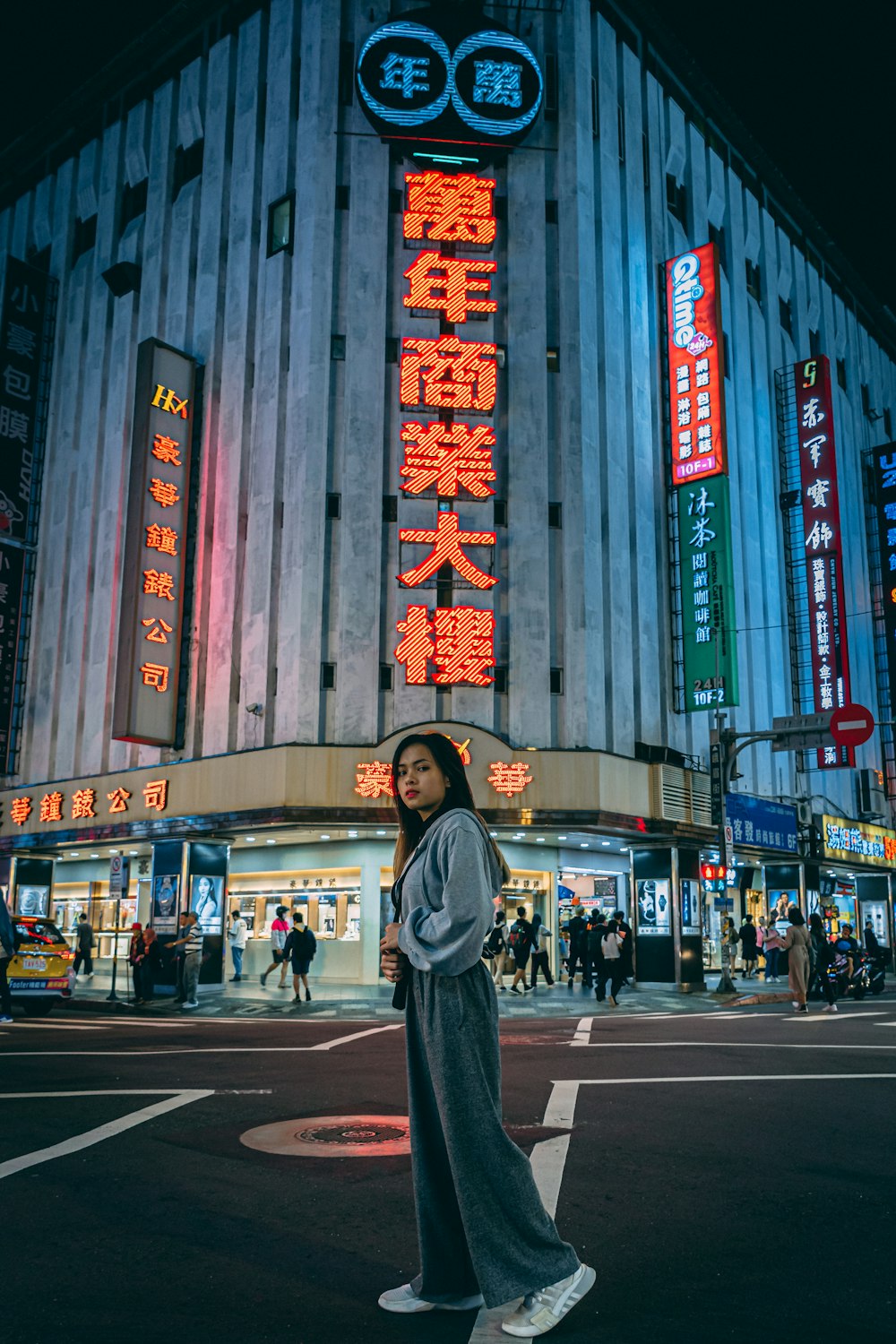 woman in black hijab standing in front of the building