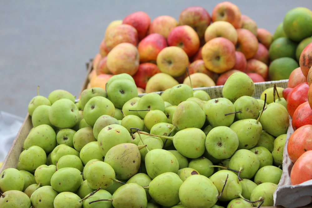 green and red apples on stainless steel rack