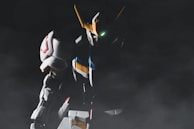 A towering nephilim giant in titan plate armor, illuminated by harsh neon blue light, gripping a massive bone saw weapon.