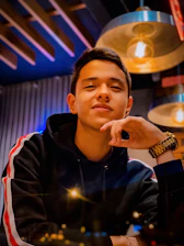 A warm, approachable photo of Shawn smiling confidently in a modern workspace.