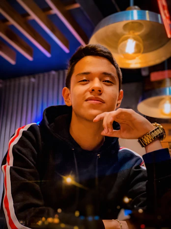 A warm, approachable photo of Shawn smiling confidently in a modern workspace.