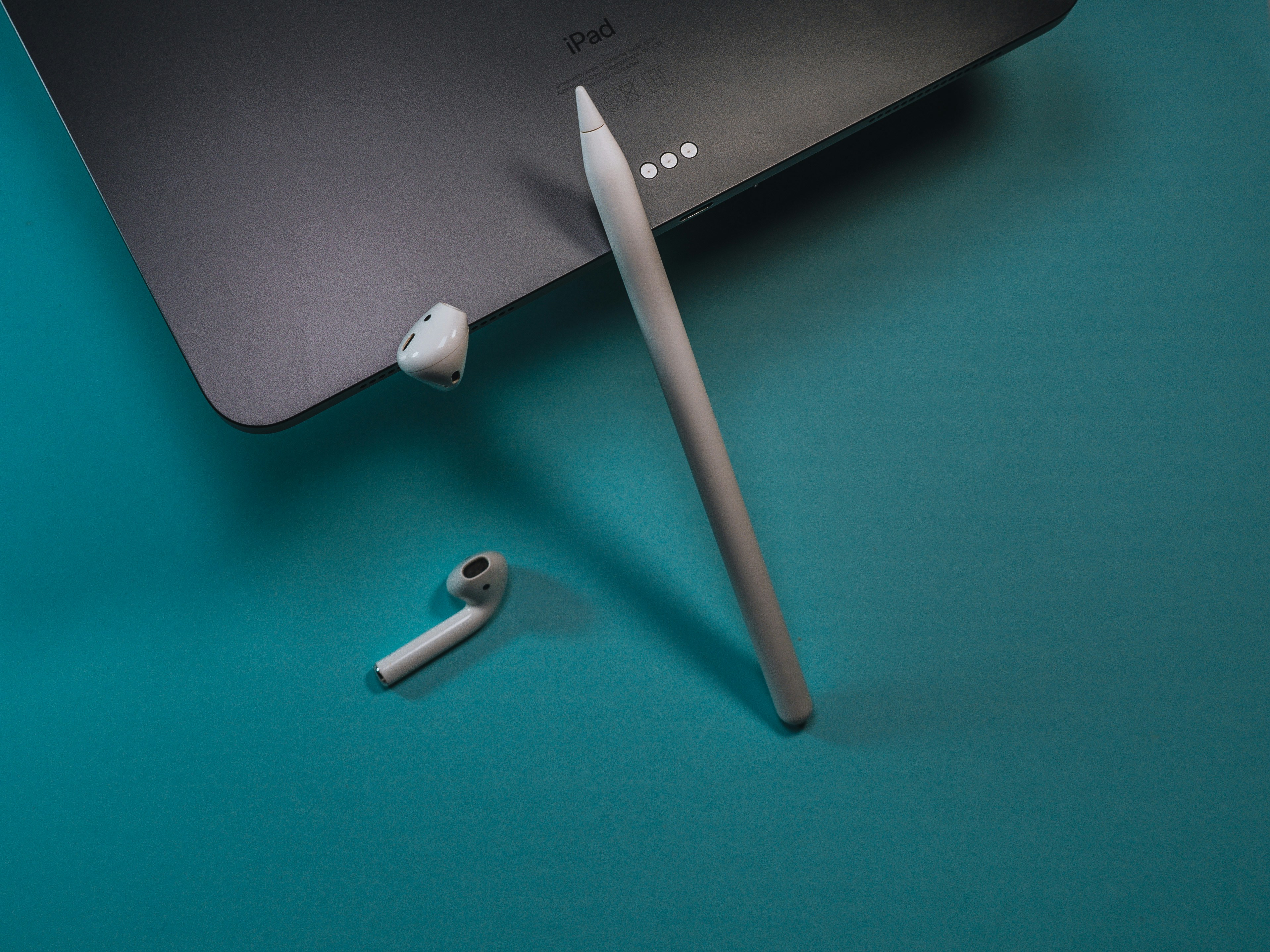 white earbuds on green table