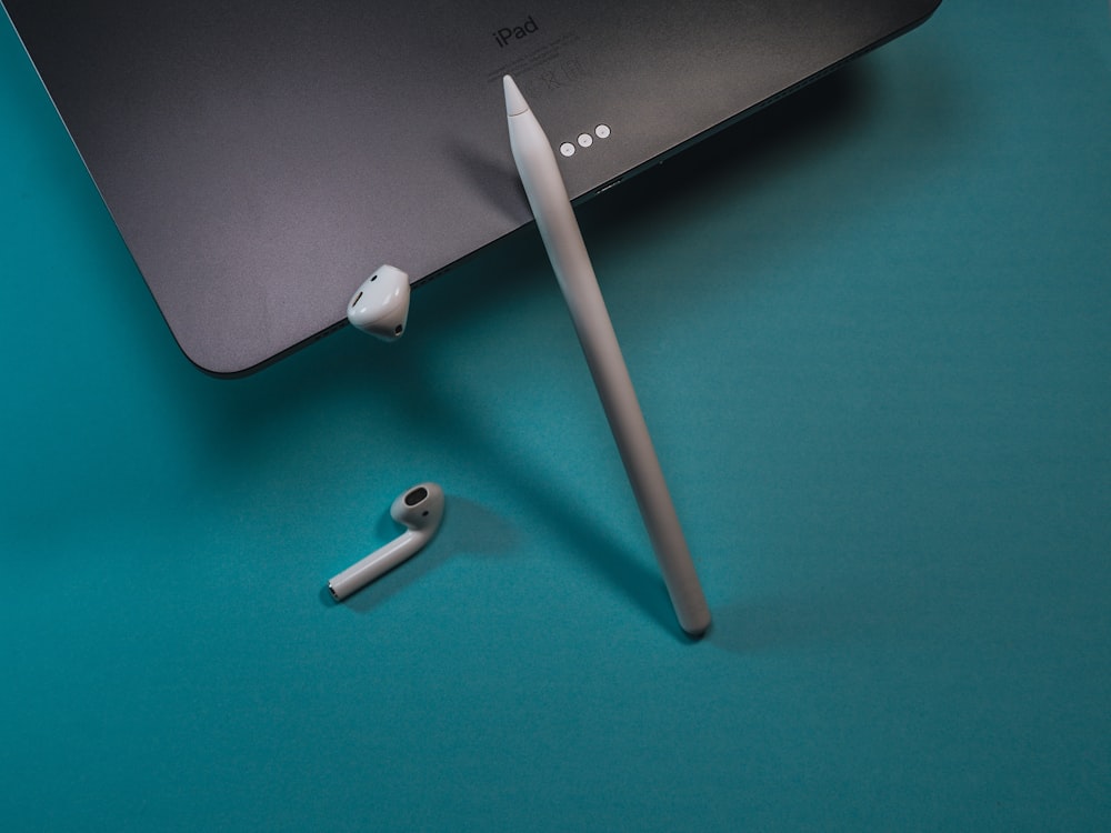 white earbuds on green table