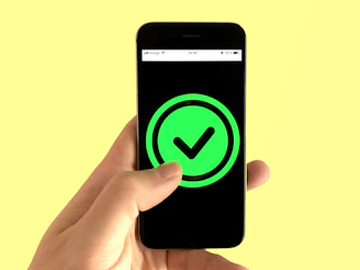 black android smartphone displaying green and black logo