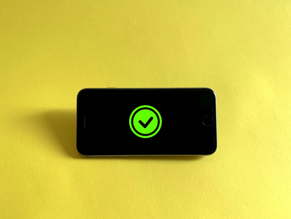 Phone with checkmark logo with a yellow background