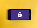 A smartphone displaying an app controlling a smart lock placed on a front door