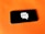 A smartphone rests on a bright orange surface. The screen displays a graphic of a white speech bubble with a wireless signal icon inside.