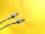Two Ethernet cables with transparent connectors are positioned against a bright yellow background. The cables are light gray, with details visible in the wiring within the connectors.
