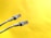 Two Ethernet cables with transparent connectors are positioned against a bright yellow background. The cables are light gray, with details visible in the wiring within the connectors.