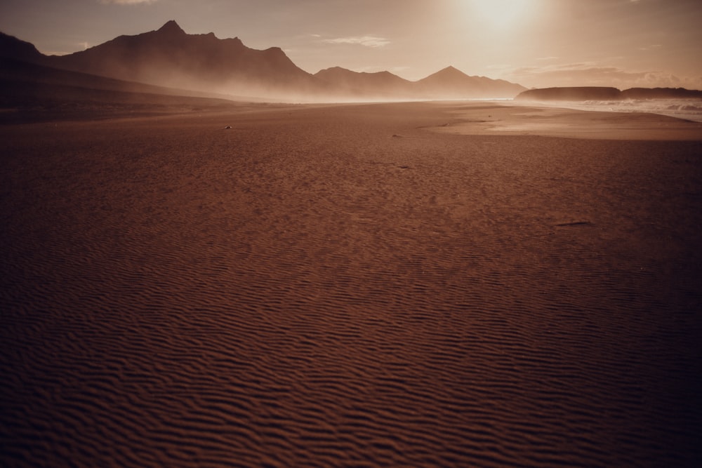 brown sand with mountain in distance