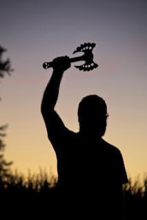 A mythical shotgun with glowing runes carved along its barrel, set against a twilight sky.