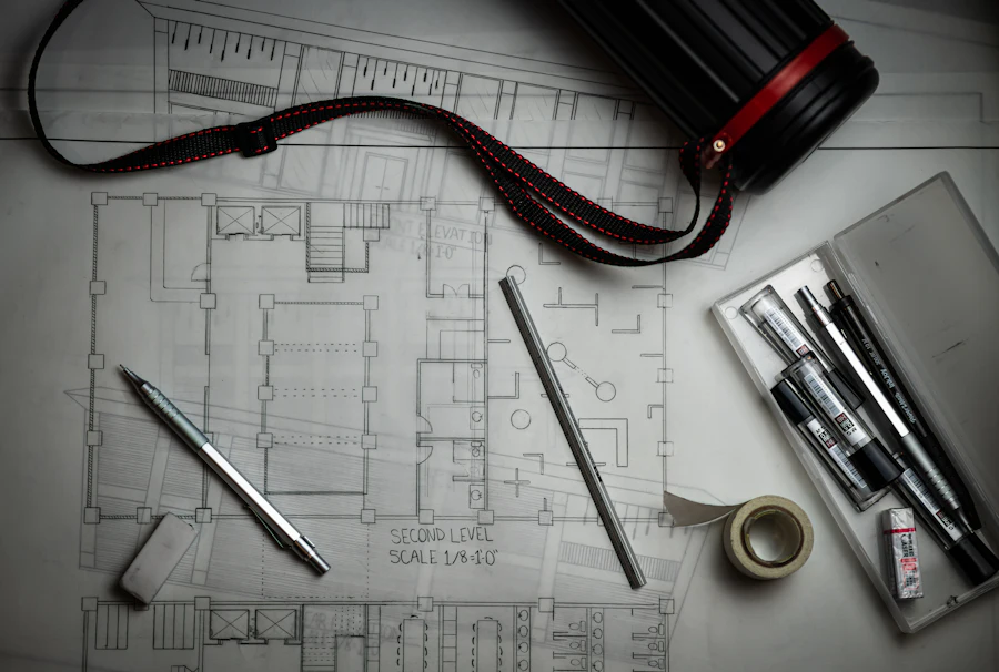 Architectural drawings laid out with drafting pencils and a metal rule
