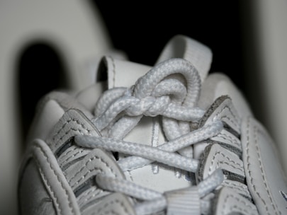 A close-up of colorful shoelaces and sneaker details.