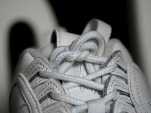 Detail of a pair of running shoes showing the textured sole and laces