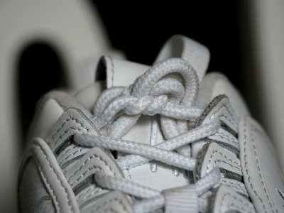 A close-up of colorful shoe laces intertwined on sneakers.