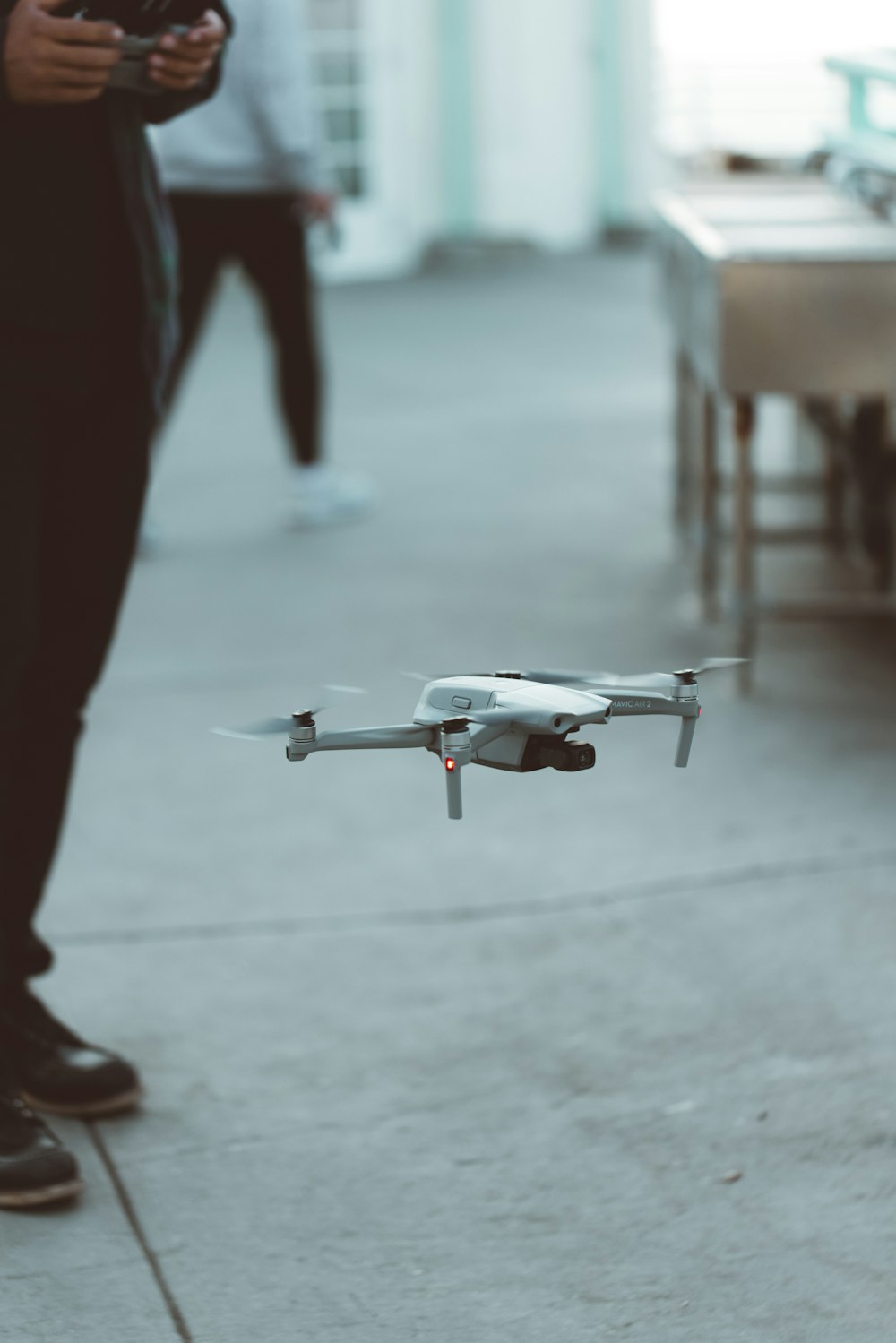 white and red drone flying