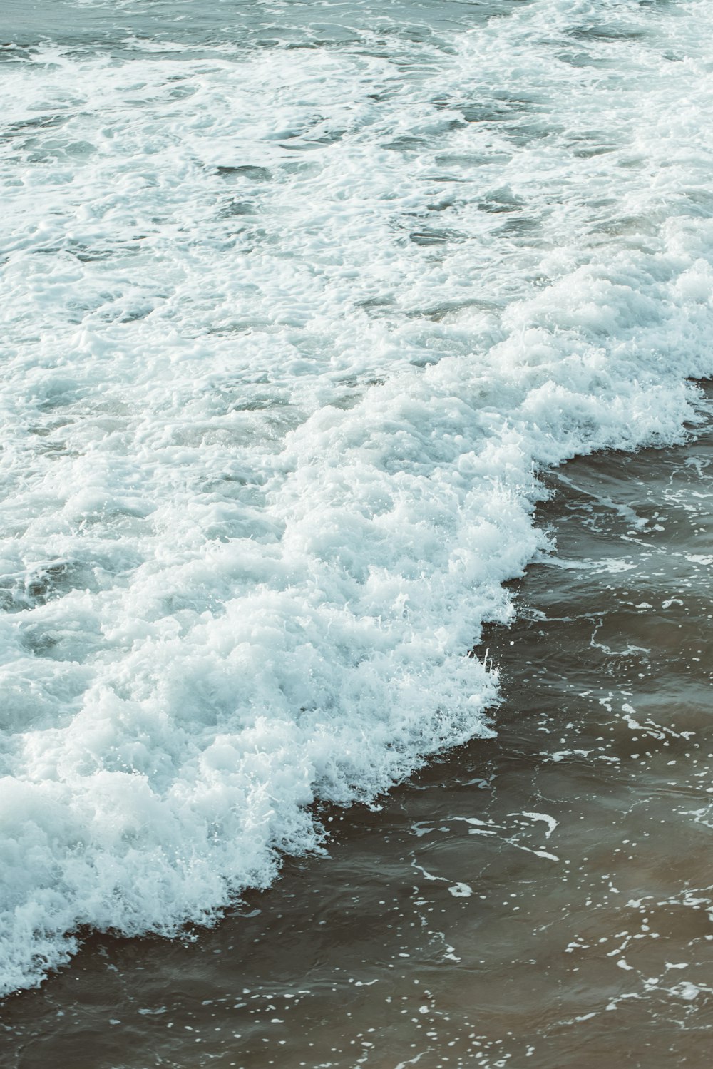 water waves on shore during daytime