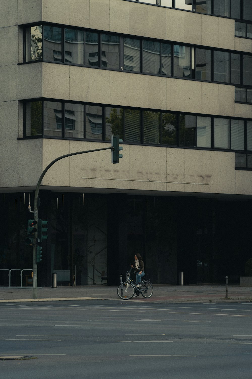 man in black jacket riding bicycle on road during daytime