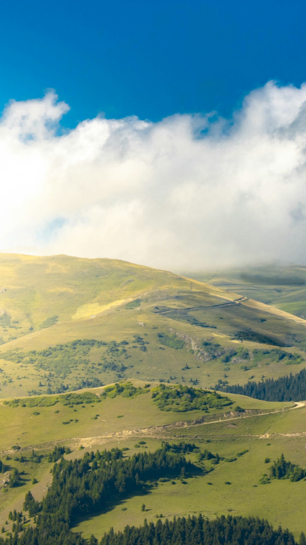 green mountains under white clouds during daytime