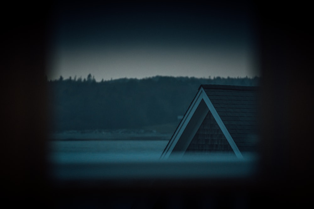 white wooden house near body of water during daytime