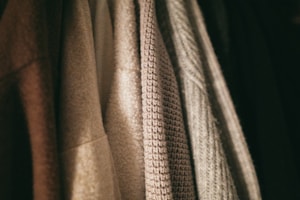 Close-up of a variety of fabric textures and colors showcasing clothing options