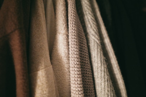 Close-up of a variety of fabric textures and colors showcasing clothing options