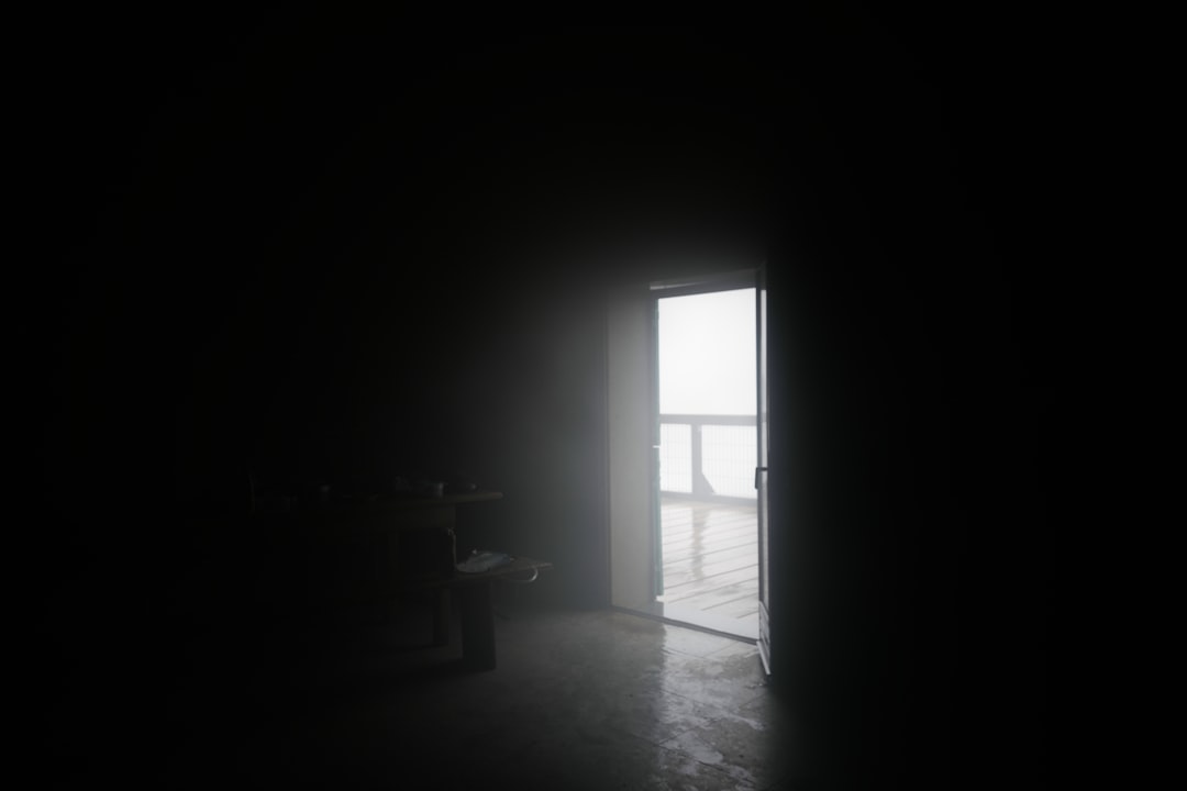 silhouette of chair near window