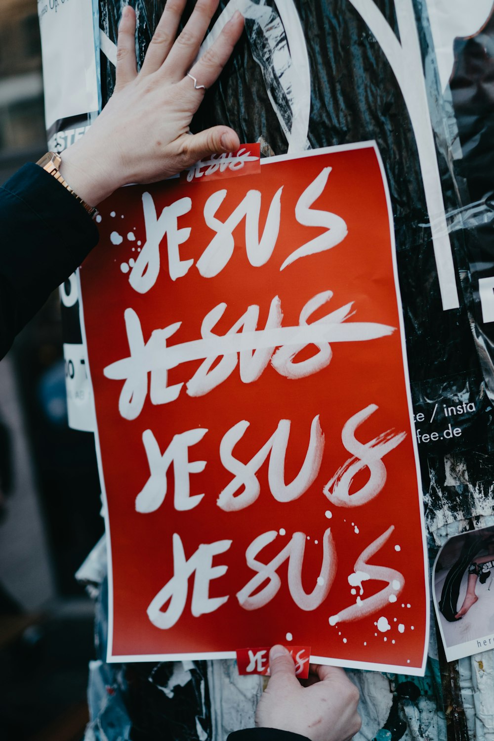 person holding red and white coca cola poster