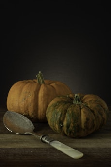 orange pumpkin on brown wooden table