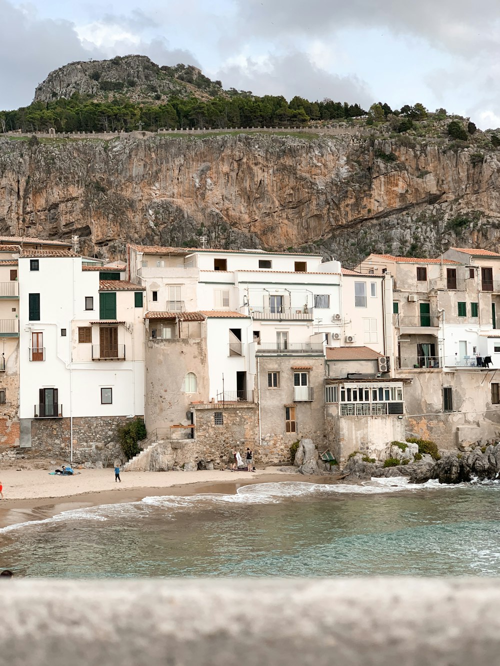 white concrete building near body of water during daytime