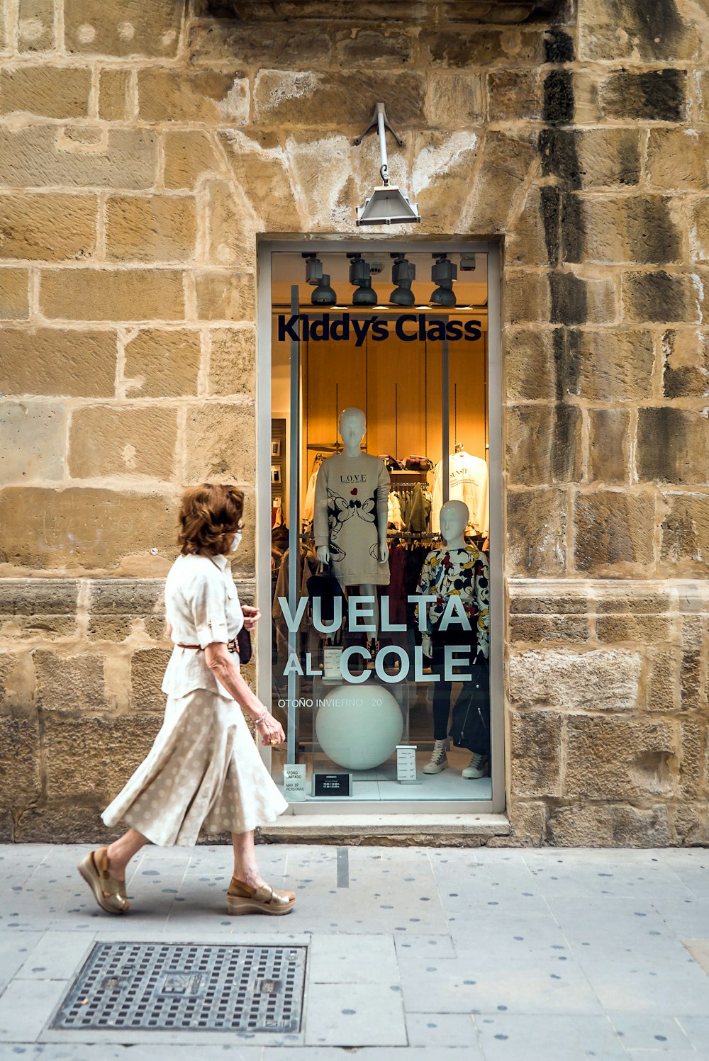 girl in white dress standing in front of blue and white wooden door