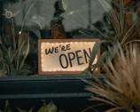 Photo of a storefront with a freshly updated sign indicating the business is open.