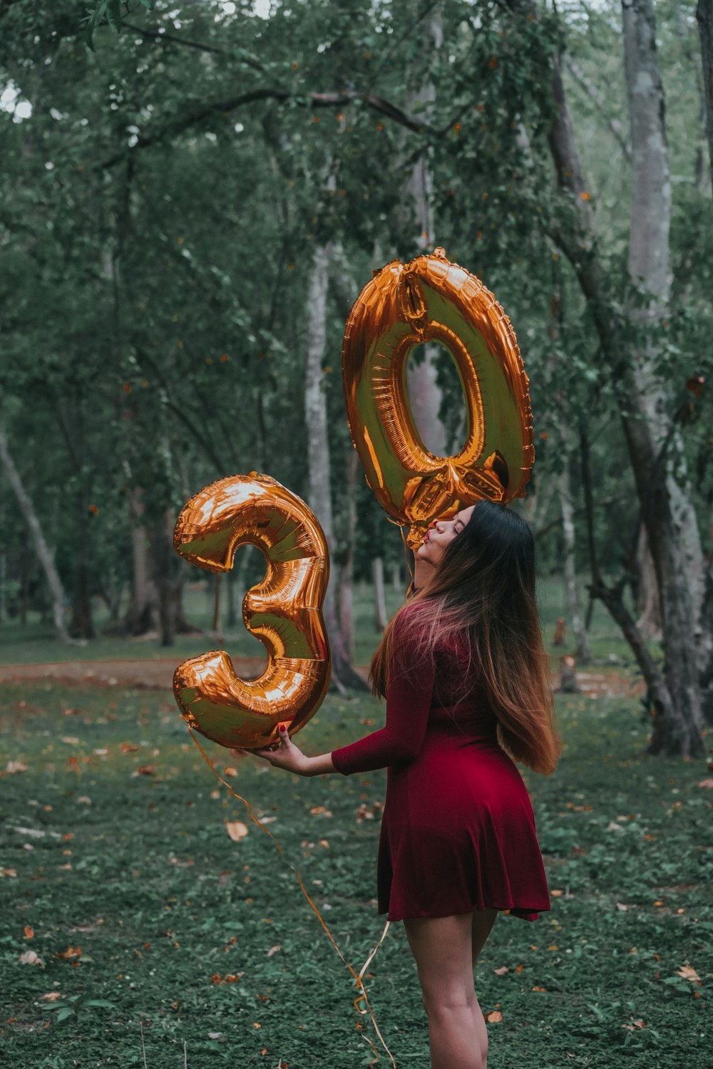 woman in red dress holding gold crown