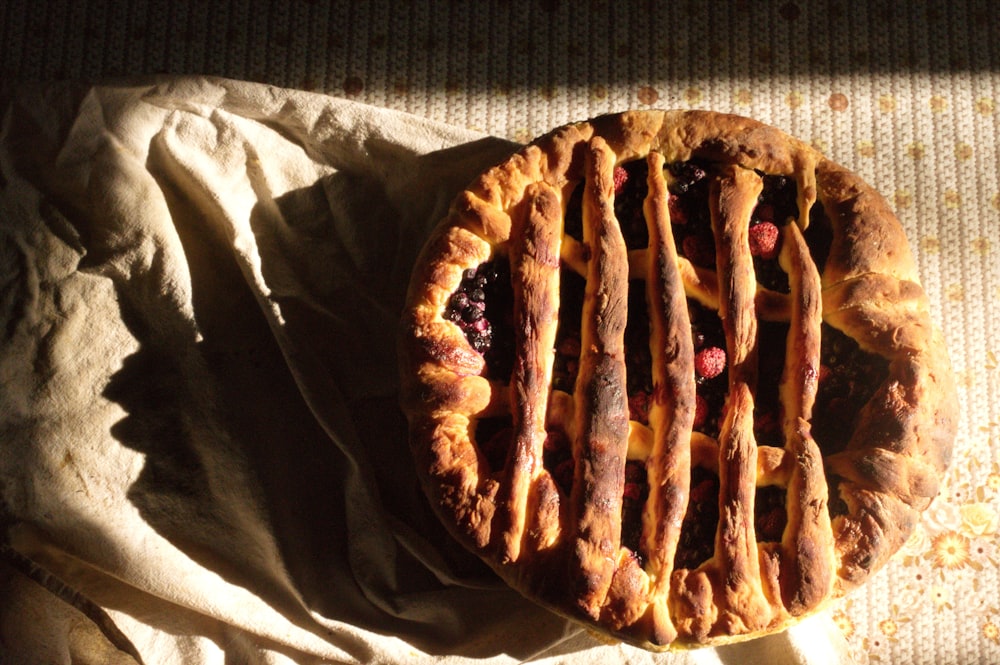 brown and white pie on brown textile