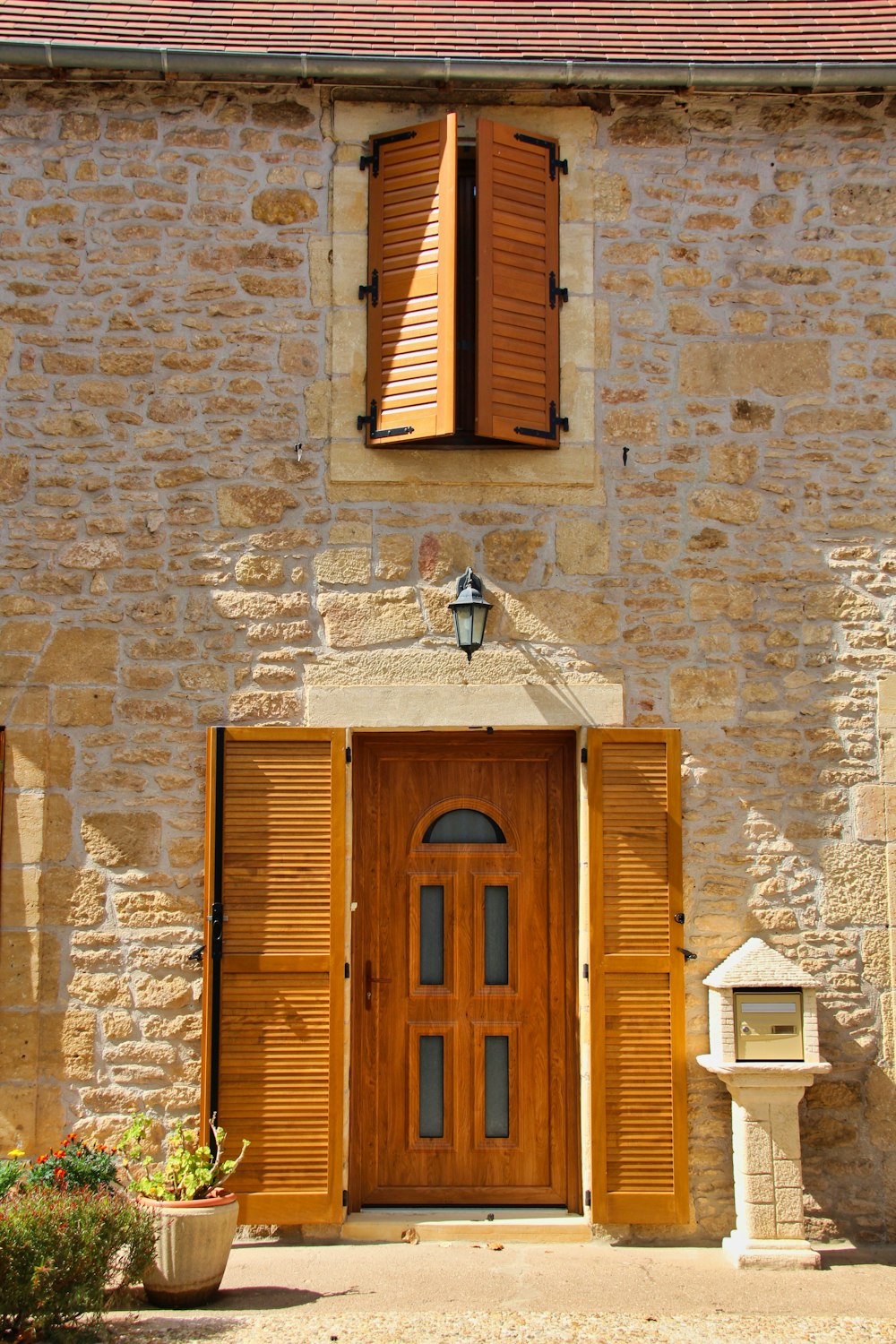 brown wooden door on brown brick wall