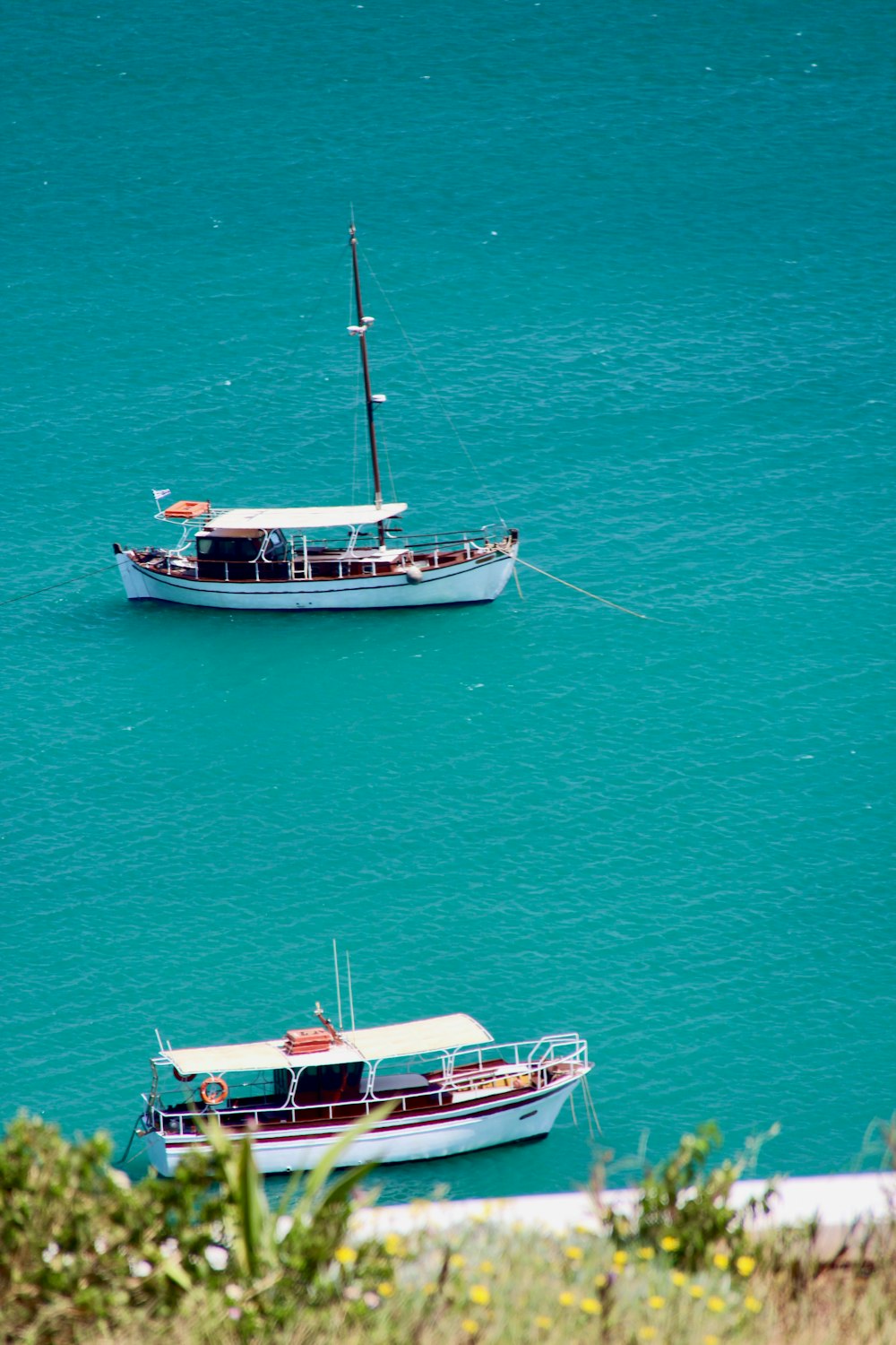 white and blue boat on sea during daytime