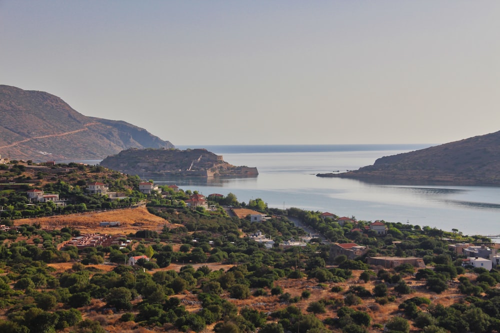 aerial view of green and brown mountains near body of water during daytime