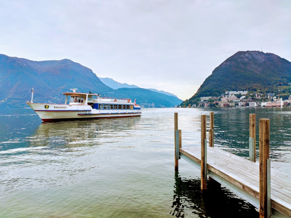 white and brown boat on body of water during daytime