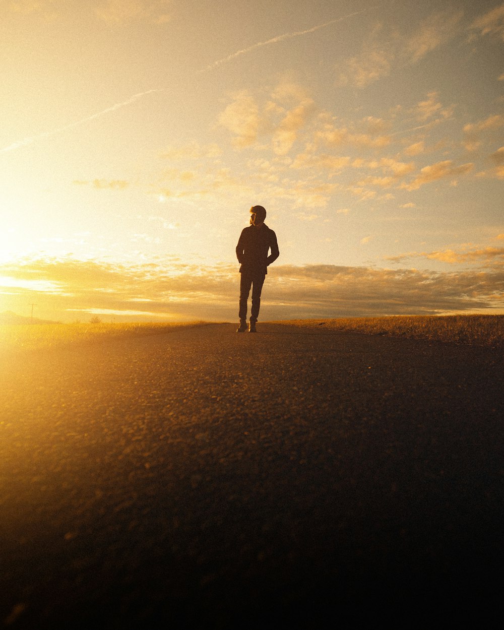 silhouette of man standing on beach during sunset