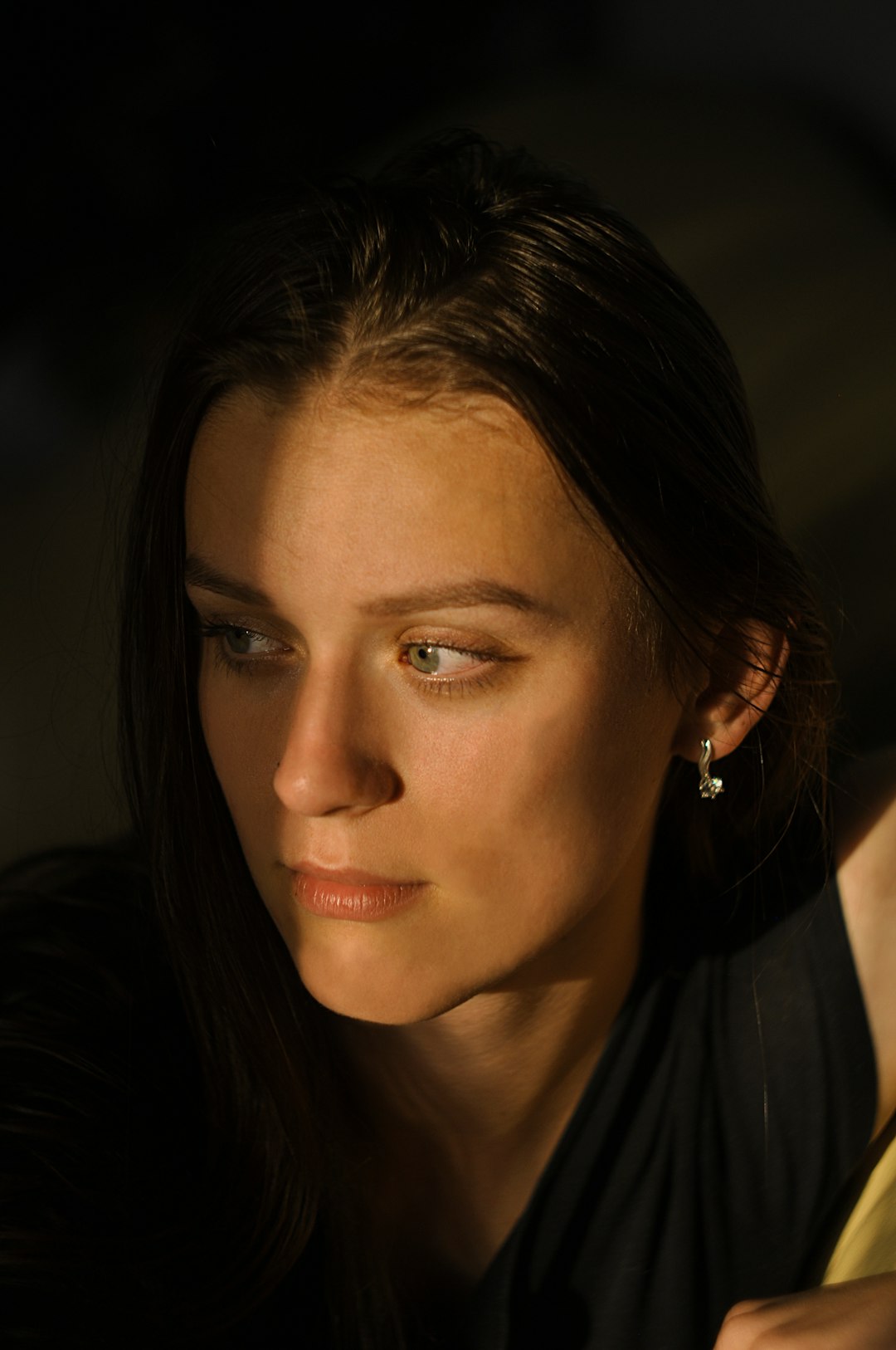 woman in black shirt wearing silver earrings