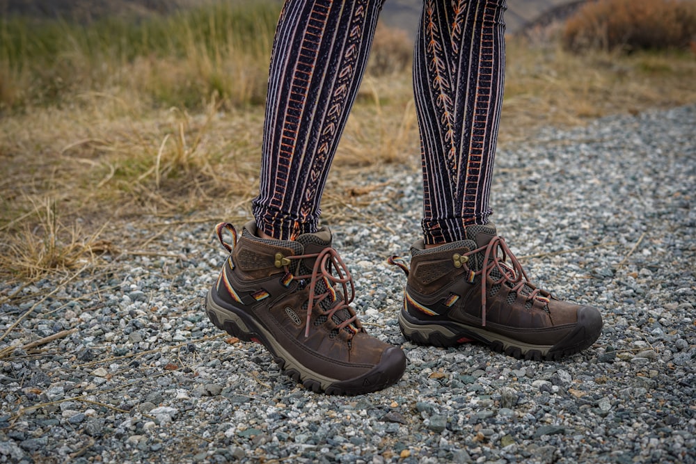 person wearing black leather hiking boots