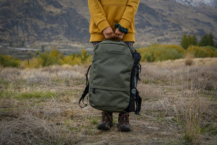 Close-up of a traveler packing a suitcase and checking a travel checklist before a trip