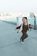 Young child running happily in a durable, stylish jacket