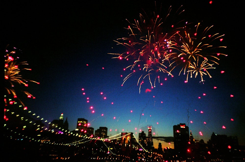 fireworks display over city buildings during night time