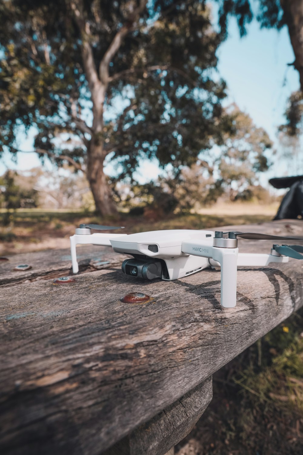 white and black drone on brown wooden table