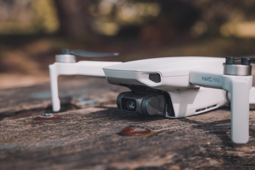 white and black drone on brown wooden table,